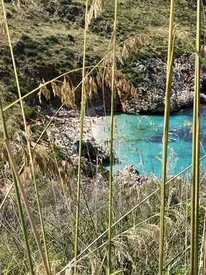 a blue river next to a field of grass at Casa Vacanza 