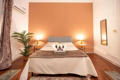 a bedroom with a bed with two towels on it at Le suite di Alba in Palermo