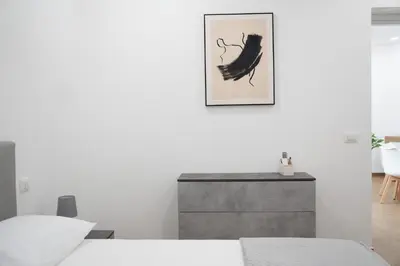 a bedroom with a bed and a picture on the wall at Home1995 in Palermo