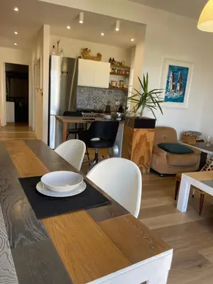 a kitchen and living room with a table and chairs at la vue sur la mer in Capaci