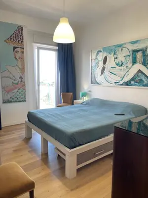 a bedroom with a large bed with a blue mattress at la vue sur la mer in Capaci