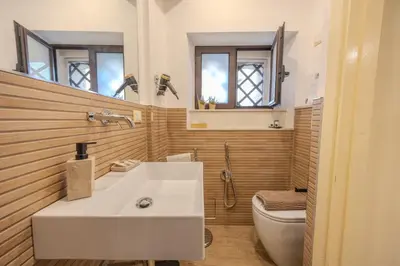 a bathroom with a white sink and a toilet at Damas Home in Palermo