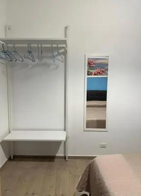a white room with a bed and a mirror at Orologio21-Soggiorna al teatro Massimo in Palermo