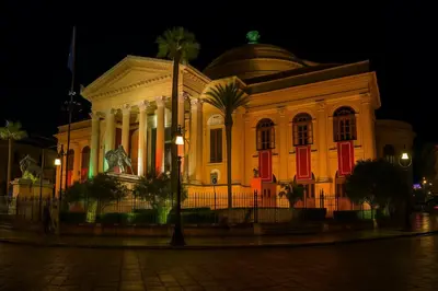 a building lit up at night at Orologio21-Soggiorna al teatro Massimo in Palermo