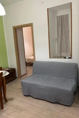 a bed sitting in a room with a mirror at Orologio21-Soggiorna al teatro Massimo in Palermo