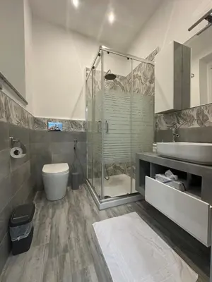 a bathroom with a shower and a toilet and a sink at Blue Wave Apartment in Palermo