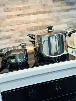 two pots and pans sitting on top of a stove at Blue Wave Apartment in Palermo