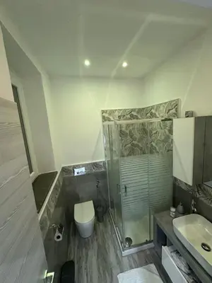 a bathroom with a shower and a toilet and a sink at Blue Wave Apartment in Palermo