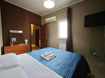 a bedroom with a bed with towels on it at Casa Pitrè in Palermo