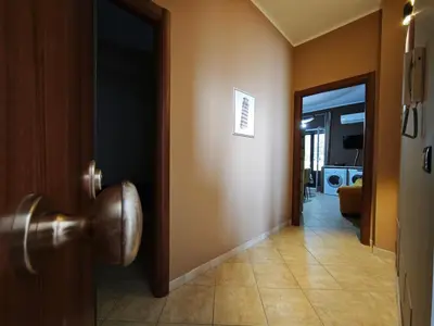 a hallway with a door open to a room at Casa Pitrè in Palermo