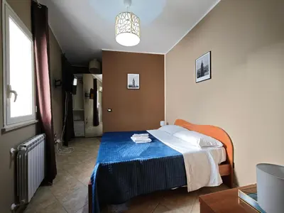 a bedroom with a bed with a blue blanket at Casa Pitrè in Palermo