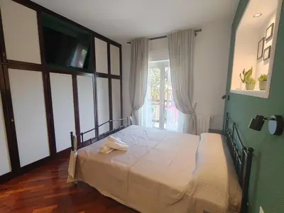 a bedroom with a bed with a television and a window at Quintadecima Rooms in Palermo
