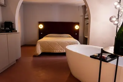 a bedroom with a bed and a bath tub at Chiave di Volta luxury suite e rooms in Palermo