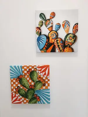 two pictures of cacti on a white wall at Casa Sciàpó in Terrasini