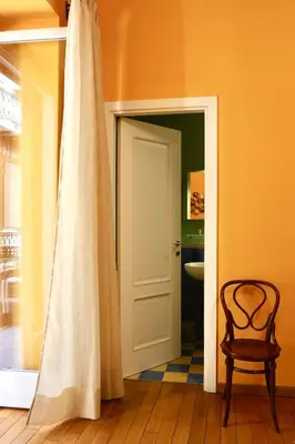 a room with a door and a chair and a toilet at Maria's apartment alla Magione, appartamento in centro in Palermo