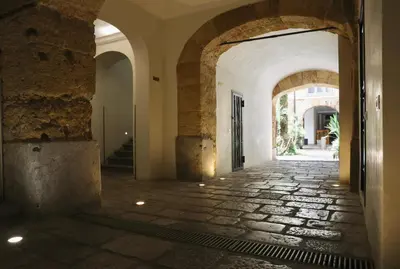 an alleyway in an old building with arches at Maria's apartment alla Magione, appartamento in centro in Palermo
