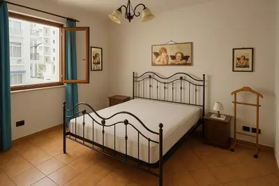 a bedroom with a bed and a window at SetteDì Apartment in Palermo