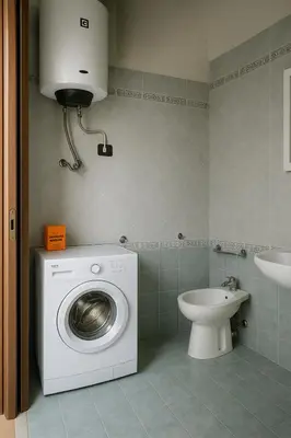 a bathroom with a washing machine and a toilet at SetteDì Apartment in Palermo