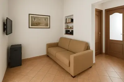 a living room with a couch and a window at SetteDì Apartment in Palermo