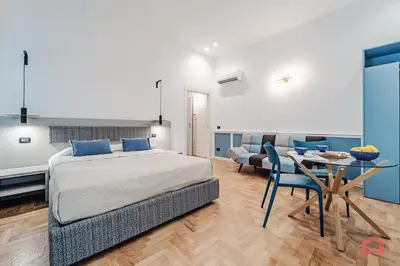 a bedroom with a bed and a table and a couch at New Holiday Home in Palermo in Palermo