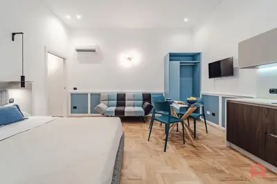 a bedroom with a bed and a table and chairs at New Holiday Home in Palermo in Palermo