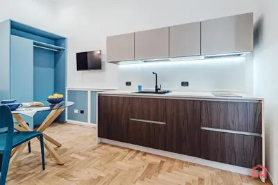 a kitchen with wooden cabinets and a table and a tableablish at New Holiday Home in Palermo in Palermo