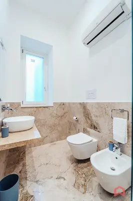 a bathroom with a sink and a toilet and a mirror at New Holiday Home in Palermo in Palermo