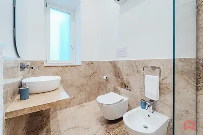 a bathroom with a sink and a toilet and a mirror at New Holiday Home in Palermo in Palermo