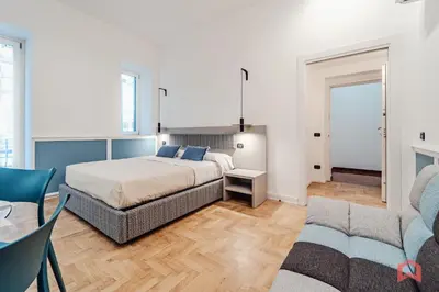 a bedroom with a king sized bed and two chairs at New Holiday Home in Palermo in Palermo