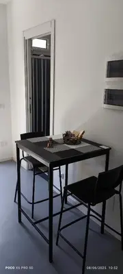 a black table and two chairs in a room at La Riali in Palermo