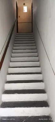 a stairway leading up to a door in a building at La Riali in Palermo