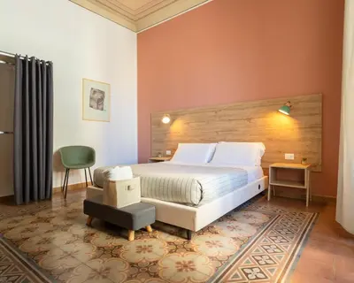 a bedroom with a large bed and a chair at Expa in Palermo