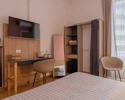 a bedroom with a bed and a desk with two chairs at Expa in Palermo