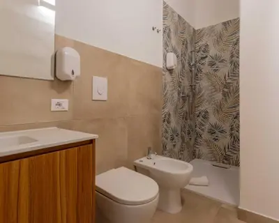 a bathroom with a toilet and a sink and a shower at Expa in Palermo