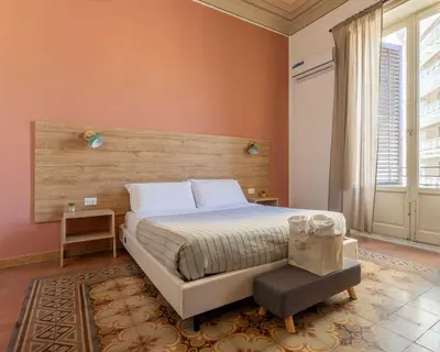 a bedroom with a large bed and a chair at Expa in Palermo