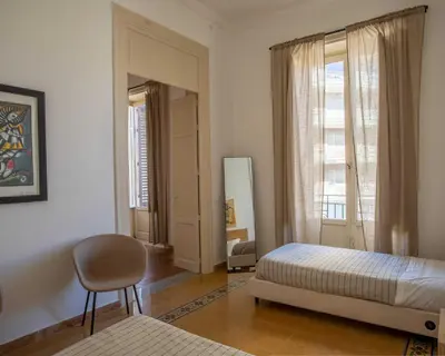 a bedroom with a bed and a chair and a mirror at Expa in Palermo