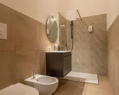 a bathroom with a sink and a toilet and a mirror at Expa in Palermo