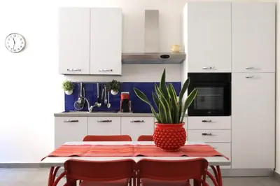 a kitchen with a table with a plant on it at Appartamenti Marì 1 in Palermo