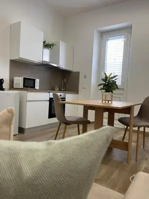 a kitchen with a table and chairs in a room at Donna Franca in Cinisi
