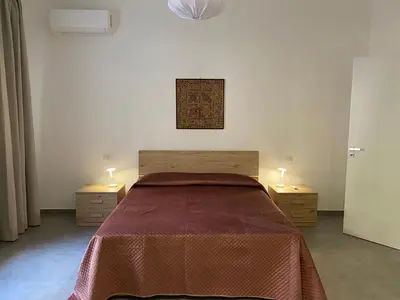 a bedroom with a large bed with two night stands at Appartamenti Mari' 2 in Palermo