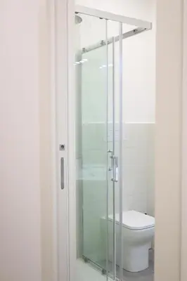 a glass shower in a bathroom with a toilet at Appartamenti Mari' 2 in Palermo