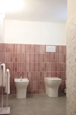 a bathroom with a toilet and a sink at Appartamenti Mari' 2 in Palermo