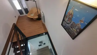 an overhead view of a staircase with a picture on the wall at Oltre i Canti in Palermo