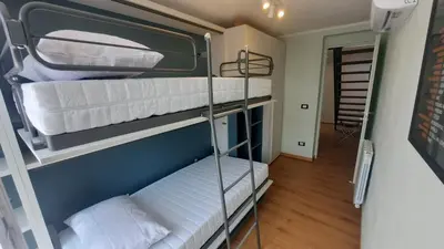 a room with three bunk beds in a room at Oltre i Canti in Palermo