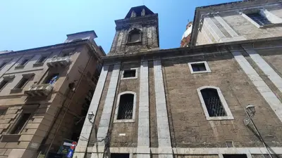 a tall brick building with a clock tower at Oltre i Canti in Palermo