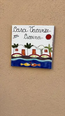 a sign on a wall with a sign on it at Casa Ciccina in Palermo