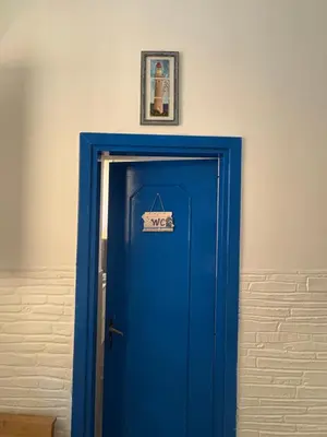 a blue door with a sign on top of it at Casa Ciccina in Palermo