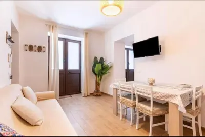 a living room with a table and a couch at La casetta di Andrea in Palermo