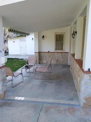 a patio with chairs and a stone wall at Il Giardino di Lia in Palermo