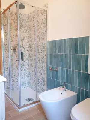 a bathroom with a shower with a tub and a sink at Il Giardino di Lia in Palermo